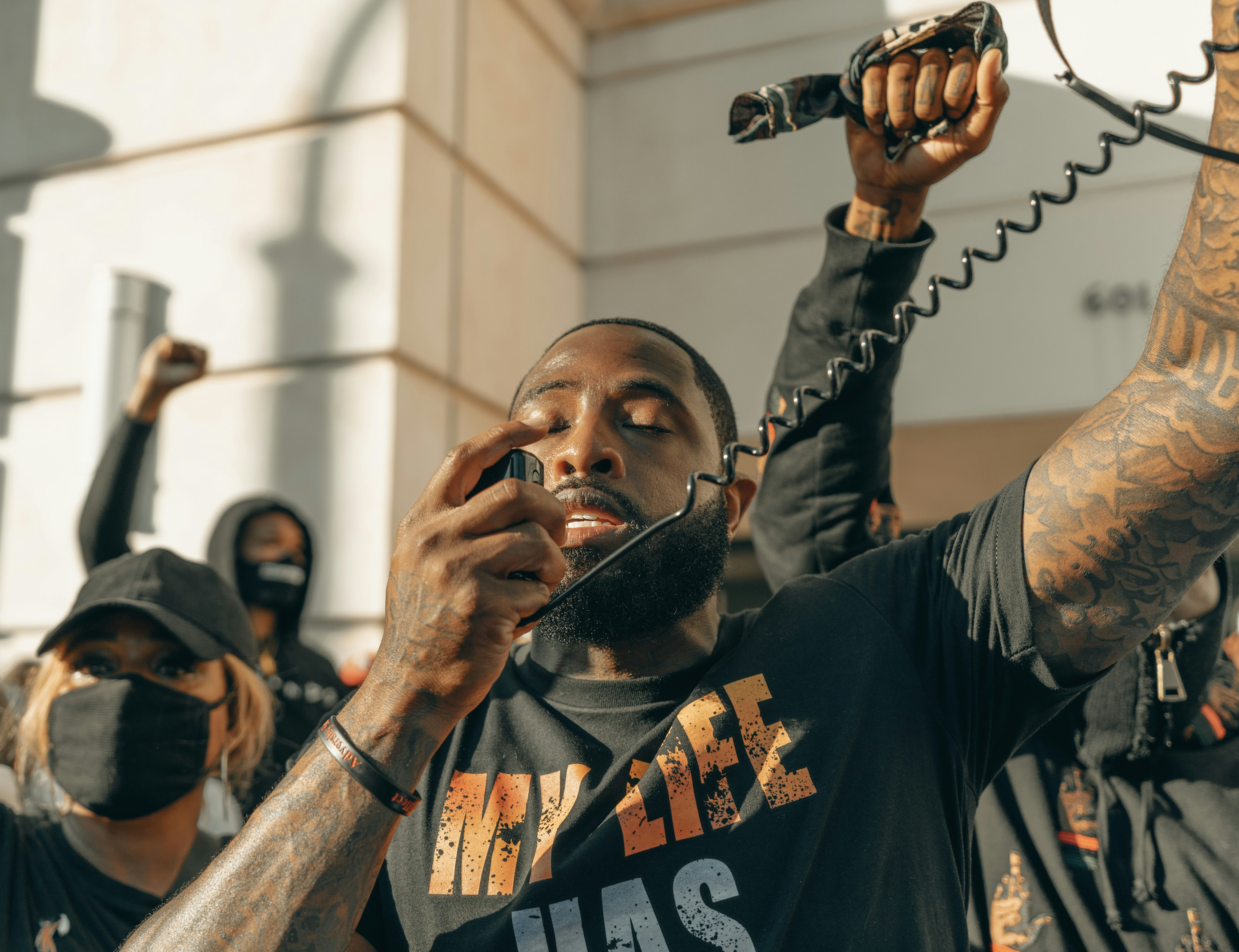 man in black crew neck t-shirt holding microphone